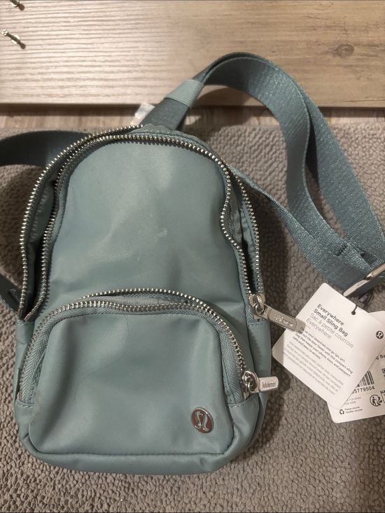lululemon athletica Handbags - lululemon gray-green Mini Sling Backpack with Silver Hardware